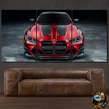 Load image into Gallery viewer, BMW M3 G80 canvas wall art featuring a red sports car front view split into three panels above a brown leather sofa.