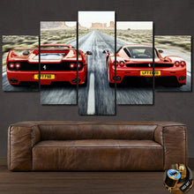 Load image into Gallery viewer, Multi-panel canvas print of red Ferrari F50 and Enzo cars on a desert road above a brown leather sofa, F50 Enzo Canvas artwork