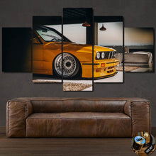 Laden Sie das Bild in den Galerie-Viewer, BMW E30 M3 yellow car multi-panel canvas wall art above leather sofa