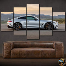 Load image into Gallery viewer, Five-piece framed car photo wallpaper canvas print featuring a silver sports car against a mountain backdrop above a brown leather sofa