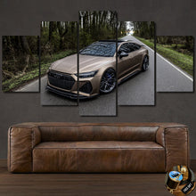 Load image into Gallery viewer, Audi RS7 C8 canvas wall art featuring a luxury car on a forest road, multi-panel framed print above a brown leather sofa