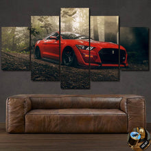 Load image into Gallery viewer, Ford Mustang GT500 red car canvas wall art in forest setting above brown leather sofa