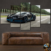 Load image into Gallery viewer, Bugatti Chiron canvas wall art featuring black sports car in motion on road, multi-panel framed print above brown leather sofa