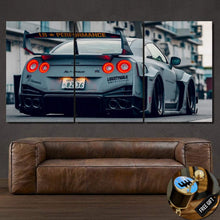 Load image into Gallery viewer, GTR Liberty Walk sports car rear view canvas wallpaper print split in three panels above a brown leather sofa