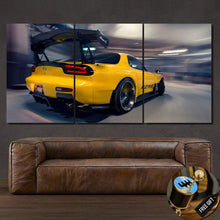 Load image into Gallery viewer, Yellow Mazda RX7 car sports canvas wall art in three panels above brown leather sofa