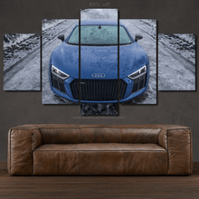Load image into Gallery viewer, Audi R8 canvas wall art with a blue sports car front view split into five panels above a brown leather sofa.