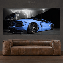 Load image into Gallery viewer, Blue Lamborghini Aventador canvas wall art with lightning background above brown leather sofa