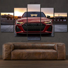 Load image into Gallery viewer, Audi RS7 Canvas wall art showing a red sports car front view in a 5-piece framed canvas set above a brown leather sofa