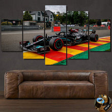 Load image into Gallery viewer, Multi-panel canvas wall art featuring a Formula 1 racing car on a colorful race track, perfect for sports car enthusiasts.