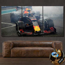 Load image into Gallery viewer, Formula F1 Canvas wall art showing a smoking race car in three framed panels above a brown leather sofa with a free gear shifter keychain gift displayed.