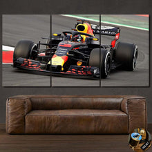 Load image into Gallery viewer, Formula F1 Canvas wall art featuring a racing car split into three framed panels above a brown leather sofa.