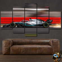 Load image into Gallery viewer, Formula F1 Canvas wall art featuring a speed racing car in motion, multi-panel framed canvas print above brown leather sofa