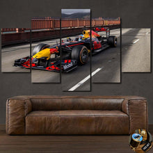 Load image into Gallery viewer, Formula F1 Canvas multi-panel wall art featuring a Red Bull racing car on a road above a brown leather sofa