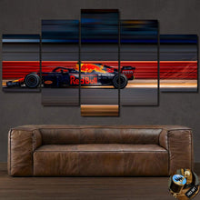 Load image into Gallery viewer, Multi-panel Formula F1 Canvas wall art featuring a Red Bull racing car on a track above a brown leather sofa