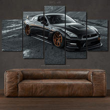 Load image into Gallery viewer, Nissan GT-R R35 black sports car multi-panel canvas wall art above brown leather sofa