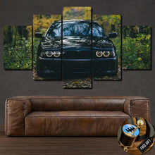 Load image into Gallery viewer, BMW E39 Canvas multi-panel framed wall art featuring a black BMW E39 front view in a forest setting, ideal for sports car enthusiasts.