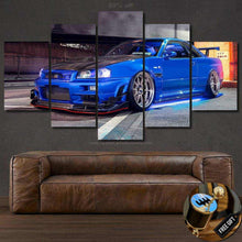 Load image into Gallery viewer, Nissan GT-R R34 blue sports car canvas wall art above brown leather sofa