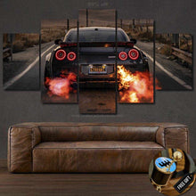 Load image into Gallery viewer, Nissan GT-R R35 rear view canvas wall art with flames and five-panel design above brown leather sofa