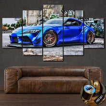 Load image into Gallery viewer, Blue Toyota Supra MK5 sports car canvas wall art above brown leather sofa with free gear shifter keychain gift
