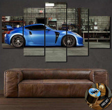 Load image into Gallery viewer, Nissan 370Z blue sports car canvas wall art in 5-piece set above brown leather sofa