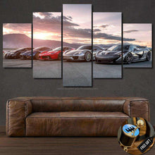 Load image into Gallery viewer, Multi-panel canvas wall art featuring Bugatti Veyron and other sports cars at sunset above a leather sofa