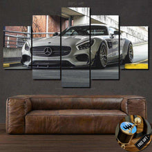 Load image into Gallery viewer, Multi-panel canvas car photo wallpaper print featuring a silver sports car above a brown leather sofa