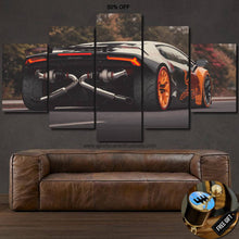Load image into Gallery viewer, Lamborghini Huracan canvas wall art showing rear view of the sports car with orange rims above a brown leather sofa