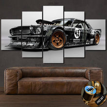 Load image into Gallery viewer, Ford Mustang Hoonicorn multi-piece canvas wall art above brown leather sofa, black and gold sports car design, free shipping and keychain gift included