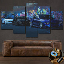 Load image into Gallery viewer, BMW M Power M3 and M4 car photo canvas wall art with graffiti background, multi-panel framed print above brown leather sofa