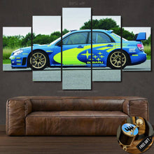 Load image into Gallery viewer, Multi-panel STI WRC Canvas wall art featuring a blue and yellow Subaru rally car above a brown leather sofa with free gear shifter keychain gift.