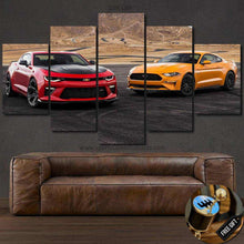 Load image into Gallery viewer, Multi-panel canvas wall art featuring a red Chevrolet Camaro and yellow Ford Mustang parked side by side on a racetrack