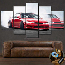 Load image into Gallery viewer, Multi-panel canvas wall art featuring a red Nissan Silvia S14 sports car drifting on a racetrack above a brown leather sofa