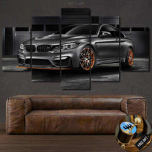 Load image into Gallery viewer, BMW M4 GTS black sports car canvas wall art five-piece set above brown leather sofa