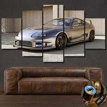 Load image into Gallery viewer, Toyota Supra MK4 car photo canvas wall art with five framed panels above leather sofa, free gear shifter keychain gift