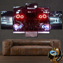 Laden Sie das Bild in den Galerie-Viewer, GT-R R35 Canvas wall art showing rear view of a red sports car with exhaust flames above a brown leather sofa
