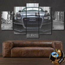 Load image into Gallery viewer, Multi-panel canvas wall art featuring a sleek Audi car front view displayed above a brown leather sofa