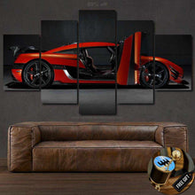 Load image into Gallery viewer, Multi-panel canvas wall art featuring a red Koenigsegg Agera one:1 sports car with open door above a brown leather sofa