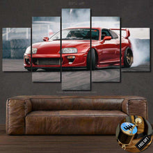 Load image into Gallery viewer, Red Toyota Supra car multi-panel canvas wall art above brown leather sofa