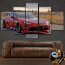 Load image into Gallery viewer, Five-piece Toyota GT86 canvas wall art featuring a red sports car in a natural outdoor setting above a brown leather sofa