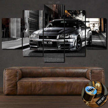 Load image into Gallery viewer, Multi-panel Nissan GTR canvas wall art above brown leather sofa, sports car enthusiast gift