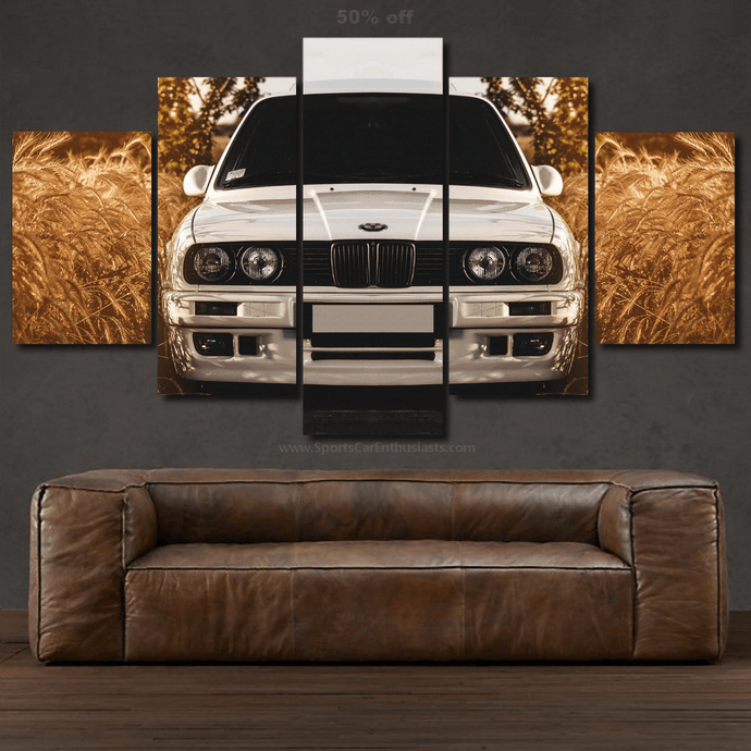 BMW E30 car photo split canvas wall art above brown leather sofa in living room