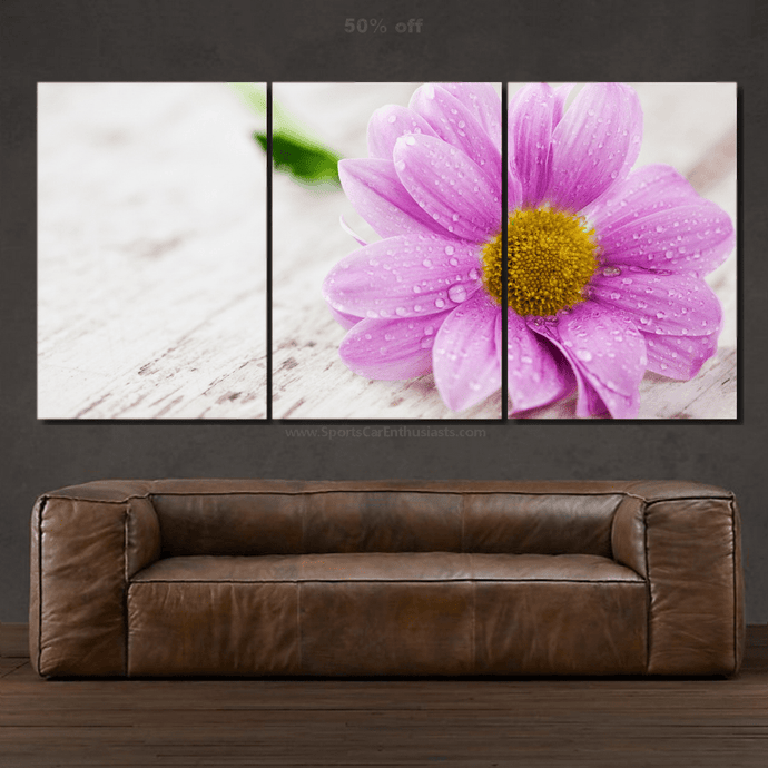 Three-piece canvas wall art featuring a close-up of a pink flower with water droplets above a brown leather sofa, Canvas 3pcs FREE Shipping.