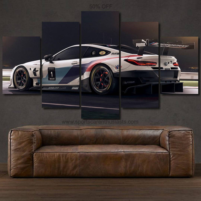 BMW M8 GTE canvas wall art with multi-panel racing car print above brown leather sofa