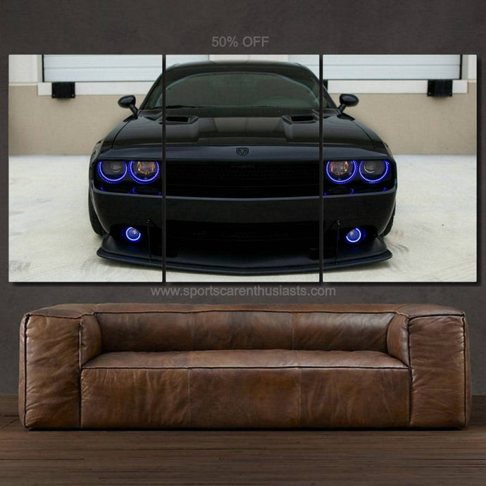 Dodge Challenger canvas wall art triptych with black muscle car and blue headlights above brown leather sofa