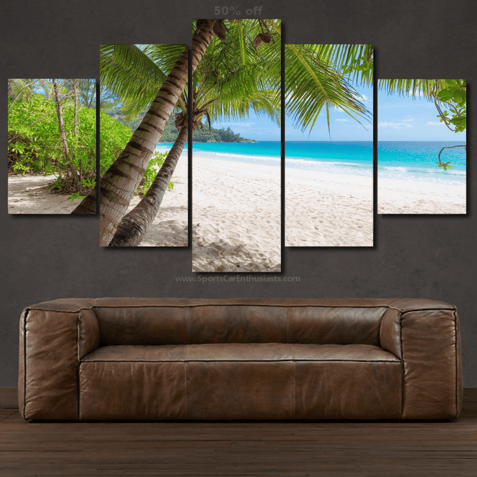 Canvas 5pcs wall art set featuring tropical beach scene with palm trees above brown leather sofa