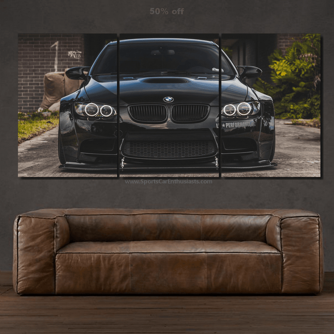 BMW M3 Canvas 3-piece framed wall art showing a black sports car front view above a brown leather sofa