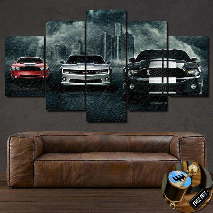 Muscle Cars Canvas 5-piece wall art featuring three sports cars in a rainy cityscape above brown leather sofa