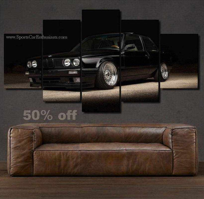 BMW E30 Canvas 5-piece wall art featuring a black sports car above a brown leather sofa